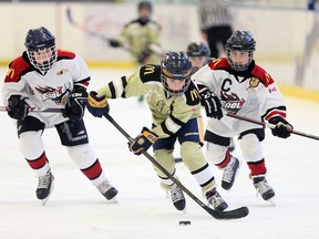 LaSalle's Steven Toniolo, centre, breaks away from Tecumseh's R.J. Koppeser, left, and Marshall Dowie in atom division action at the 23rd annual Hockey for Hospice Tournament at Lakeshore's Atlas Tube Centre on Dec. 27, 2018.