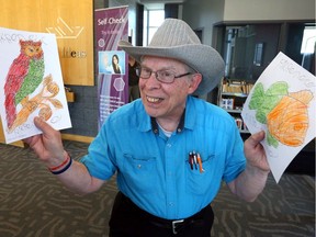 Proud of his work, Rick Renaud shows off his colouring at Staying Between the Lines, Adult Colouring at Windsor Public Library Friday.  Renaud and others with intellectual disabilities attended with support workers Lori Bezaire and Kelly Peltier (not shown).