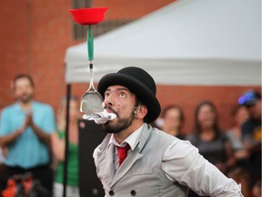 Venezuelan street performer Katay Santos balances an array of items on a spoon with his mouth at Busk on the Block in Walkerville on Friday, Aug. 9, 2019. The street performers continue their feats on Saturday.