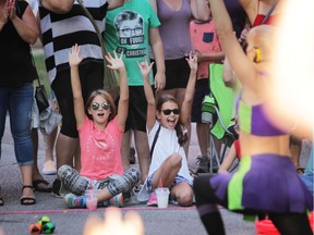 And the crowd goes wild. Two girls cheer on a busker at Busk on the Block in Walkerville.