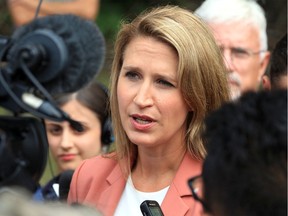 Ontario Transportation Minister Caroline Mulroney is pictured in this Aug. 12 file photo when she and MPP Rick Nicholls, behind, announced the Ontario government is widening Highway 3 from two to four lanes in the towns of Essex and Leamington.