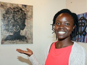 Tamara Gamble is part of the Rapha Youth Outreach Services.  In the photo, Gamble shows one of the pieces of art at Core Gallery, part of the Black Youth Express Power exhibit. Black youth ages 9 to 12 are expressing what makes them feel powerful in a new exhibit at the Core Gallery.