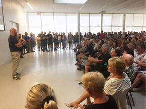 Lakeshore chief administrative officer Truper McBride, left, talks to a large crowd during a flooding update meeting hosted by the Essex Region Conservation Authority on Monday, Aug. 12, 2019.