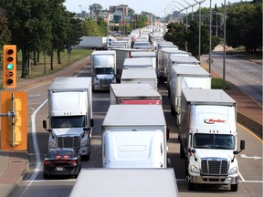 Hundreds of transport trucks cover all three lanes on northbound Huron Church Road at Girardot Street Tuesday afternoon.  Windsor Police tried to maintain order by educating some truckers who were using the local lane.