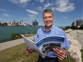 University of Windsor professor John Hartig, shown on the Windsor waterfront west of Crawford Avenue on Wednesday, holds a report on the economic spinoffs the Great Lakes cleanup.