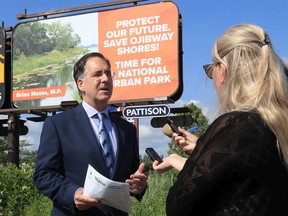 MP Brian Masse holds a roadside press conference announcing a townhall meeting on a national urban park for Ojibway Shores and surrounding parks and nature conservation areas.