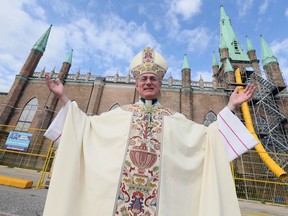 Bishop Ronald Fabbro, Diocese of London, following mass for the Feast of Our Lady of the Assumption at Assumption Chapel, Thursday at 8 A.M.  Bishop Fabbro announced the historic Assumption Church, behind, will reopen September 8, 2019.