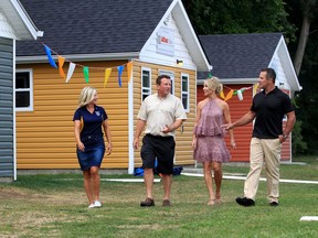 Tina Gatt, left, president of Kiwanis Club of Windsor, tours newly built cabins at Kiwanis Sunshine Point Camp with Scott Allen, COO, Integrity Tool and Mold and Stephanie and Barry Zekelman Saturday evening on Lake Erie.  The Kiwanis Club of Windsor announced another $300,000 in support of our Kiwanis Sunshine Point Camp.