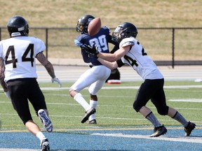 Windsor AKO Fratmen defensive back Kaeb Hellreich, right, intercepts a pass intended for GTA Grizziies Harvey Mafuta in the first half Saturday at University of Windsor Alumni Field.