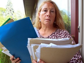 Kathy Beaudoin, pictured holding dozens of documents Wednesday said she was one of the people who contacted police after the Oct. 22 municipal election in Essex.