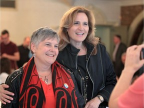 Melinda Munro, left, poses with Sandra Pupatello Friday after announcing she was withdrawing her candidacy for the Liberal nomination in Windsor West and supporting Pupatello. The former Ontario cabinet minister and Windsor West MPP announced last week she wants the federal seat.