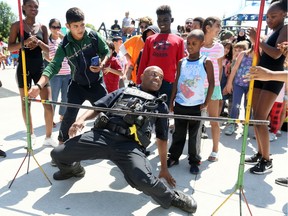 Windsor, Ontario. August 24, 2019 -- Windsor Police Const. Neil McEachrane shows his flexibility while in uniform during 3rd Annual Diversity BBQ at Wigle Park Saturday.   In partnership with Windsor Police Services, Unemployed Help Centre, Windsor Chapel Funeral & Cremation, New Beginnings, Connections Early Years Family Centre, and the Multicultural Council, Windsor Fire and Rescue Services celebrates their 3rd Annual Diversity BBQ on Saturday, August 24, 2019 from 11:00 a.m. to 2:00 p.m. at Wigle Park (Erie Street East at McDougall).