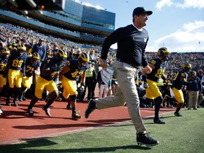 Head coach Jim Harbaugh of the Michigan Wolverines leads the team onto the field prior to playing the Illinois Fighting Illini on October 22, 2016 at Michigan Stadium in Ann Arbor, Michigan. Michigan won the game 41-8.