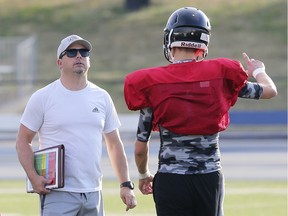 Windsor AKO Fratmen head coach Mike LaChance, left, speaks with quarterback Colton Allen, who helped the club to a 60-30 win over the GTA Grizzlies on Sunday.