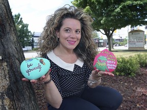 The local Bulimia Anorexia Nervosa Association has hidden more than 100 colourful rocks in Windsor-Essex with positive messages to flood social media such as Instagram with inspiring messages. The association asks that people who find the rocks take a picture and post it online with the tag #BANABEYourself and hide the rock again. Luciana Rosu-Sieza, executive director of BANA displays a couple of the rocks on Wednesday, August 14, 2019, at the organization's Windsor office.