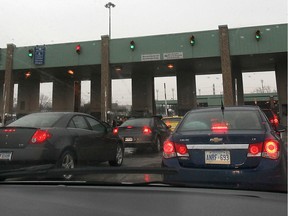 Cars queue up for Canada Customs inspection on the Windsor, Ont. side of the Ambassador Bridge on Tues. Dec. 3, 2013.