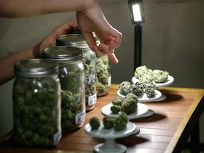 A vendor points out marijuana buds for sale at a cannabis market in Seattle in this 2013 file photo.