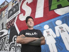 Daniel Bombardier, known as Denial in the art world, is shown in front of one of his most recent murals in downtown Windsor. The  mural, located on the side wall of an Ouellette Avenue building just north of Wyandotte Street, was commissioned by a local family.