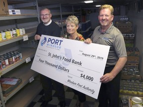 St. John Anglican Church's Rev. Gordon Maitland, left, Deb French, co-ordinator of the church's food bank, received a $4,000 ceremonial cheque Thursday from  Windsor Port Authority president and CEO Steve Salmons.