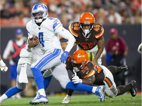 Detroit Lions quarterback Josh Johnson runs the ball for a touchdown past Cleveland Browns outside linebacker Genard Avery during the third quarter at FirstEnergy Stadium. The Browns won 20-16.