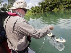 Students and researchers from the Great Lakes Institute for Environmental Research participated in a binational effort to get water samples from the western end of Lake Erie on Wednesday, August 7, 2019. Ken Drouillard a professor with the University of Windsor is shown with sampling equipment aboard GLIER's boat near LaSalle.