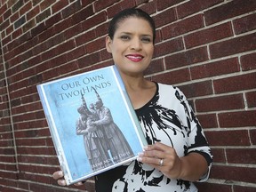 Irene Moore Davis, president of the Essex County Black Historical Research Society, is seen in this 2019 file photo with her book, Our Own Two Hands: A History of Black Lives in Windsor from the 1700s Forward.