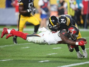 Tampa Bay Buccaneers running back Dare Ogunbowale (44) dives into the end zone to score a touchdown past Pittsburgh Steelers defensive back P.J. Locke (24) at Heinz Field. (Charles LeClaire-USA TODAY Sports)