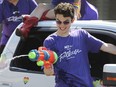 WINDSOR, ON. AUGUST 11, 2019. -- Jayden Lacoursiere of the Arts Collective Theatre group uses a water gun to spray people during the Windsor-Essex Pride Parade on Ottawa St. on Sunday, August 11, 2019.