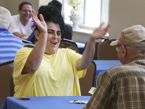 Maria Greco reacts to winning a match against Joe Spagnuolo during a Scopa tournament during the St. Angela Merici 32nd annual festival on Erie St. on Saturday August 10, 2019.