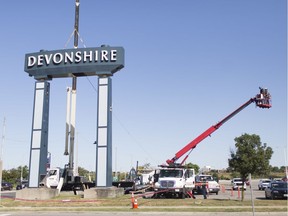 Workers took down the large Devonshire Mall sign at the Howard Avenue entrance on Friday, August 23, 2019.
