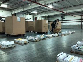 A U.S. Customs and Border Protection canine team checks a mail shipment from Canada. The agency said more than 170 shipments of small amounts of illegal drugs were seized this month from Canadian mail trucks crossing into Michigan over the Blue Water Bridge.