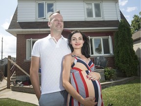 Home sweet home. Mark and Marina Sarty are shown Aug. 8, 2019, in front of their Windsor home, currently under renovation to accommodate twins expected to arrive in less than two months.