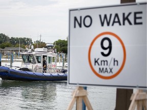 A Windsor police marine unit passes a 'No Wake' sign at Lakeview Park Marina, Tuesday, August 6, 2019.