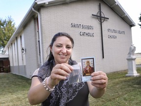 Lina Khoury a parishioner at Saint Simeon Stylites Melkite Catholic Church in Windsor is shown with a photo of an icon and a swab of oil on Wednesday, August 14, 2019 that leaked from the actual religious piece recently.