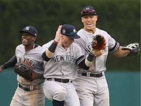 Cameron Maybin #38, Clint Frazier #77 and Aaron Judge #99 of the New York Yankees celebrate a win over the Detroit Tigers in game one of a doubleheader at Comerica Park on September 12, 2019 in Detroit, Michigan.  New York defeated Detroit Tigers 10-4.