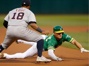 Matt Chapman #26 of the Oakland Athletics is tagged out by Dawel Lugo #18 of the Detroit Tigers while running to third base on a single hit by Matt Olson #28 at Ring Central Coliseum on Sept. 6, 2019, in Oakland, Calif.