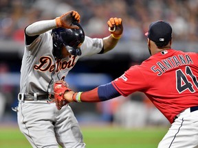 Harold Castro of the Detroit Tigers is tagged out by first baseman Carlos Santana of the Cleveland Indians during the fifth inning tries to dodge at Progressive Field on September 19, 2019 in Cleveland, Ohio.