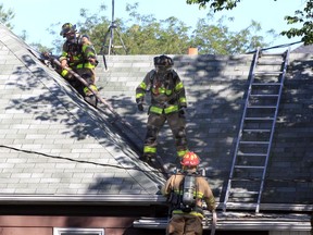 Windsor, Ontario. August 31, 2019.  Windsor firefighters stretch a water line to the attic area of 273 McKay Ave. for a working house fire Saturday at 9 A.M.  Windsor Police also attended the scene.  (NICK BRANCACCIO/Windsor Star).