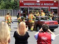 Windsor firefighters from Station 3 use hydraulic cutters and spreaders to dismantle a vehicle during a mock rescue at a Lowe's East Windsor location Saturday. The event was organized by Lino Tesolin, Lowe's store manager and proceeds will go to the Brain Injury Association.