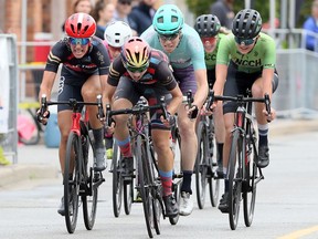 Elite Women racers Allison Sauder, centre, and race winner Jamie Gilgen, behind centre, sprint with other racers to the finish line in Tour di Via Italia International Bicycle Races on Erie Street East Sunday. Gilgen and second-place finisher Miriam Brouwer lapped the field during the race with all the cyclists bunched together at the finish line.