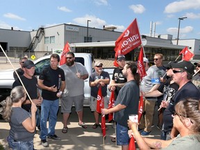 Unifor executives John D'Agnolo, left, and Chris Taylor speak Sept. 2, 2019, with Nemak workers regarding the continuous protest outside the West Windsor auto parts plant.