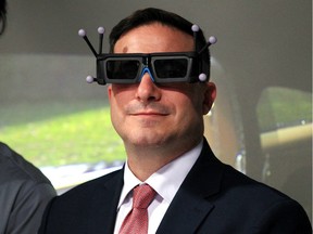 Glimpsing an innovative future, Marco Mendicino (L—Eglinton-Lawrence), parliamentary secretary to the minister of infrastructure and communities, is shown Friday, Sept. 6, 2019, on a tour of the virtual reality cave for connected and autonomous vehicles at Windsor's Cross-Border Institute during an announcement of a $5-million FedDev Ontario investment to help grow an automobility innovation cluster in the Windsor-Essex region.
