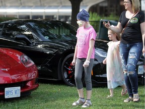 Evelyn Rollo, 9, of Windsor, looks at the Corvettes on display outside Windsor Regional Hospital's Met Campus. Rollo is a patient of the hospital's paediatric oncology unit, which received a $12,000 donation from the Corvette Club of Windsor on Tuesday, September 10, 2019.