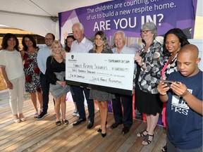 Kyrsten Solcz, centre, executive director of the Solcz Family Foundation, along with Michael Solcz, Marty Solcz, centre left, and other members of the Solcz family, left, were excited to announce on Sept. 20 a contribution of $300,000 to Windsor Family Respite's "I'm In" campaign to raise $1.5 million for a new specialized respite home. In photo, Catharine Shanahan, executive director of Family Respite Services and respite family Amber Hamelin and son, Tayvion Hamelin, right, join in the announcement.