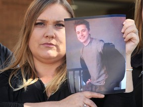 Carolyn Crankshaw holds a photo of her deceased son, Darrion Moffatt.  Crankshaw and supporters are holding a vigil on Saturday night.