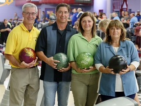 The children of Hall of Fame bowler Pat Mitchell, who passed away after being a top executive of the Chrysler Men's Bowling League for over 60 years, pose wearing their Dad's bowling shirts at Rose Bowl Lanes Tuesday night. In photo, Patrick Mitchell, left, Willie Mitchell, Valerie Petryniak and Kathy Vincent, right, were part of a brief but emotional ceremony honouring their father, Pat Mitchell at the beginning of the Chrysler Men's League.