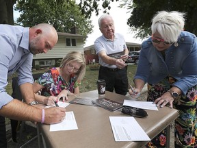 Members of 42 Forward - Our New Hospital organization held a press conference on Monday, September 9, 2019, to officially launched a petition campaign in support of the chosen location for the new mega-hospital. Jeff Casey, left, Brenda Brunelle, Gunther Wolf and Bev Valliquette sign petitions during the event.