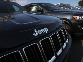 2015 Jeep Grand Cherokee vehicles are seen on a sales lot as Fiat Chrysler Automobiles announced that it is recalling more than 1.1 million cars and SUVs worldwide because the vehicles may roll away after drivers exit the vehicles on April 22, 2016 in Miami, Florida.