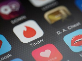 The "Tinder" app logo is seen amongst other dating apps on a mobile phone screen on November 24, 2016 in London, England.