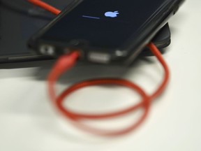 (FILES) In this file photo taken on March 18, 2019 An iPhone 6S is plugged into a battery charger in Washington,DC. - Apple sent out invitations on August 29, 2019 to a September 10 event at its Silicon Valley campus where it is expected to unveil a new-generation iPhone.In its trademark, tight-lipped style, Apple disclosed little about what it plans to spotlight in the Steve Jobs Theater at its headquarters in the city of Cupertino.For years now, Apple has hosted events in the fall to launch new iPhone models ahead of the Christmas holiday shopping season.